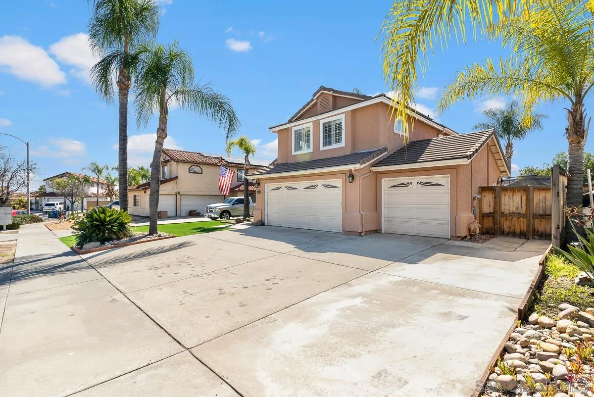 10109 Country Scenes Court Santee, CA 92071 - Photo 3 of 43 a view of a white house with a yard and palm trees