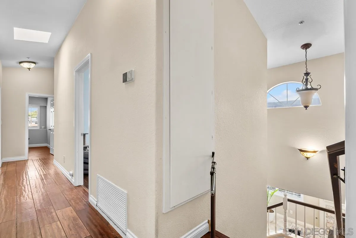 10109 Country Scenes Court Santee, CA 92071 - Photo 31 of 43 a view of a hallway with wooden floor and staircase