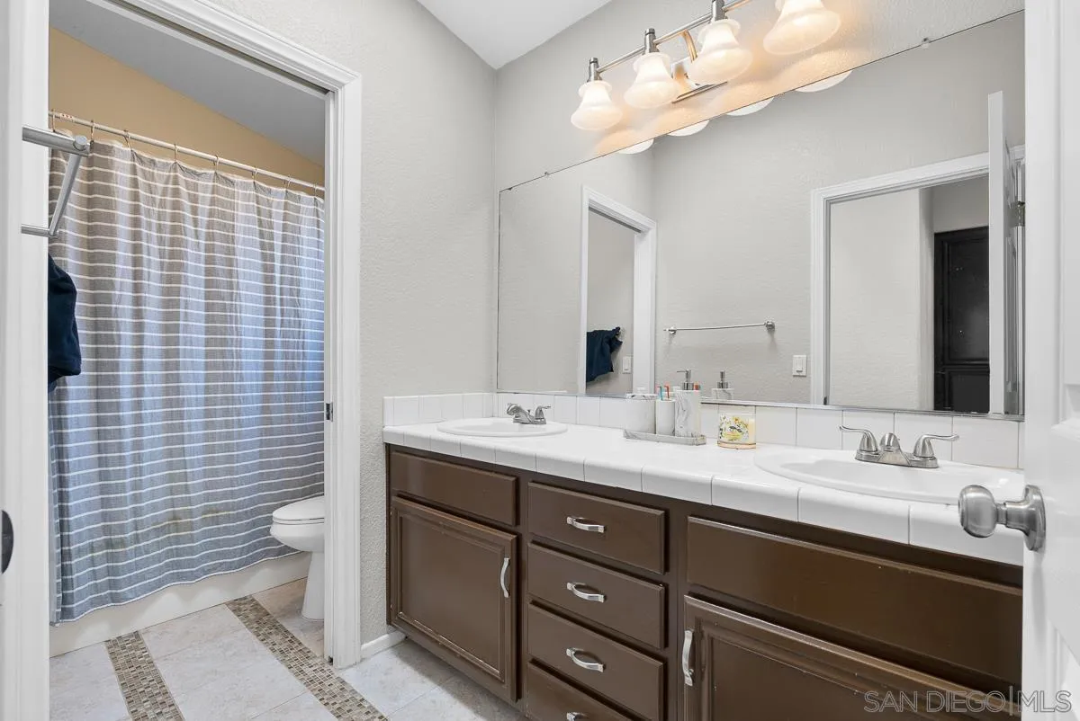 10109 Country Scenes Court Santee, CA 92071 - Photo 32 of 43 a bathroom with a double vanity sink mirror and toilet