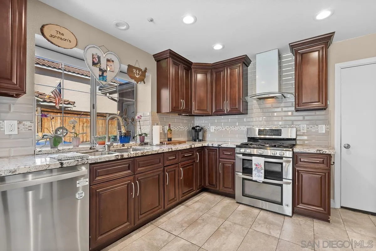 10109 Country Scenes Court Santee, CA 92071 - Photo 9 of 43 a kitchen with stainless steel appliances granite countertop a stove sink and cabinets