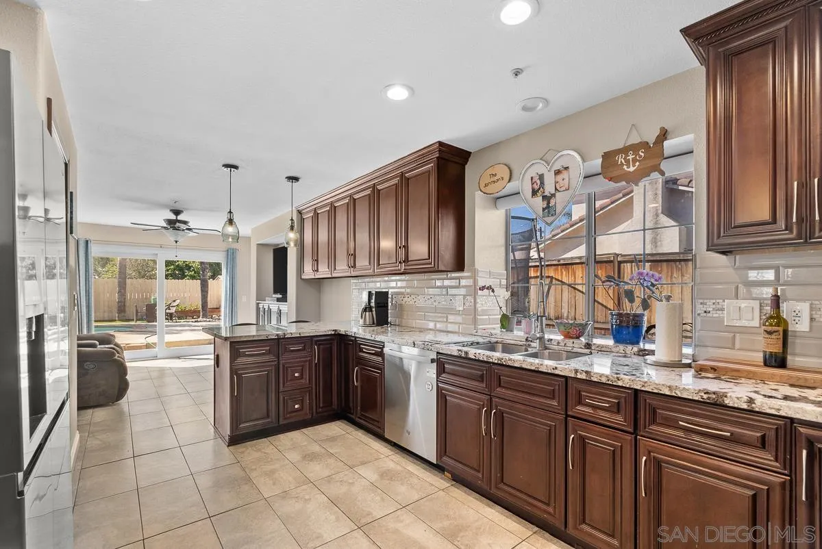 10109 Country Scenes Court Santee, CA 92071 - Photo 10 of 43 a kitchen with stainless steel appliances granite countertop a sink and cabinets