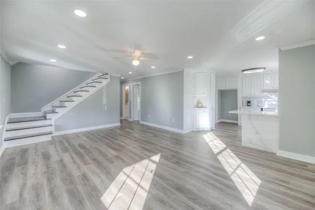 a view of empty room with wooden floor