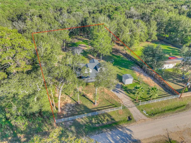 an aerial view of a residential houses with yard