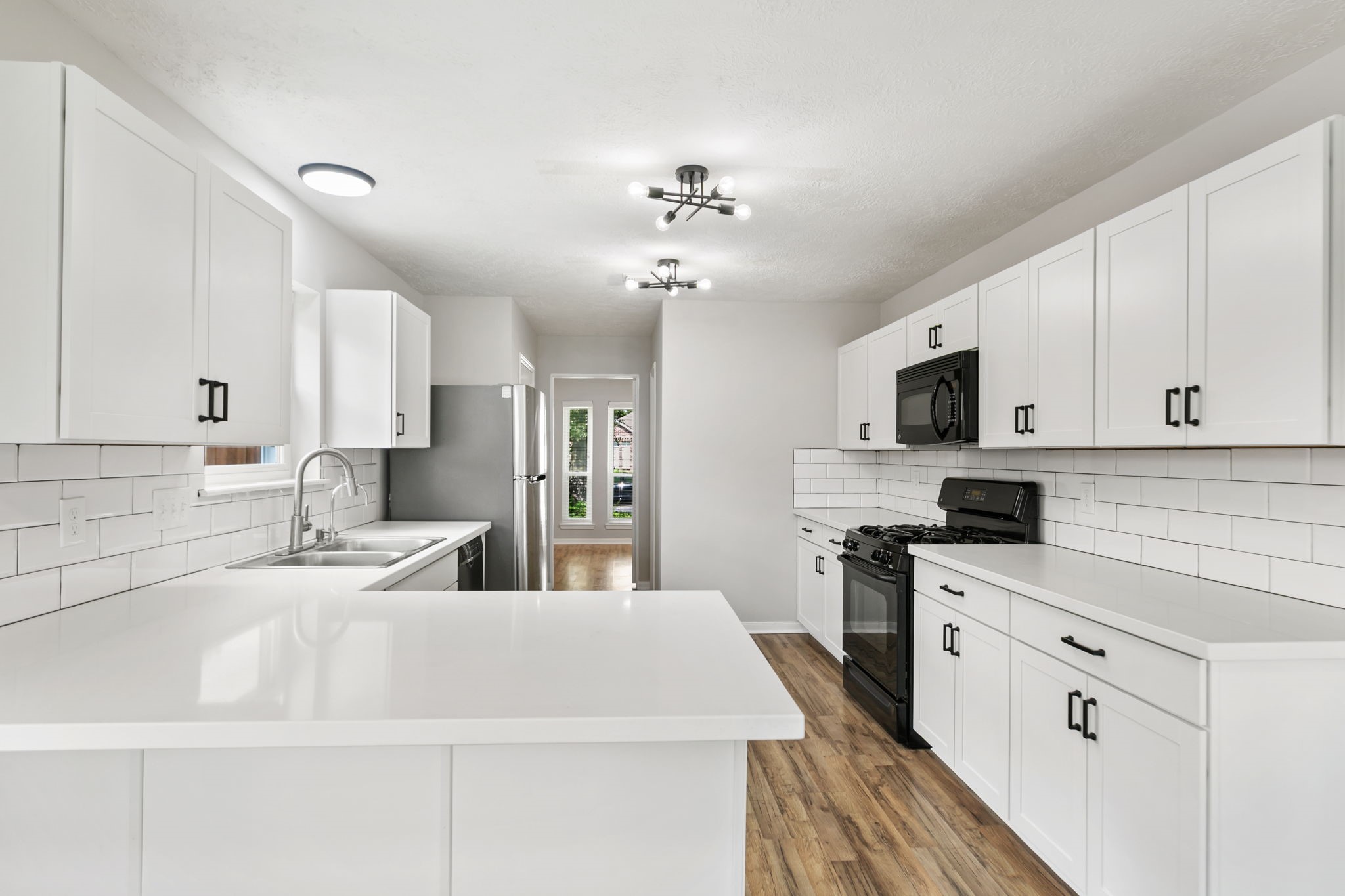 Brand new, updated kitchen with all new cabinets, hardware, countertops, and backsplash.