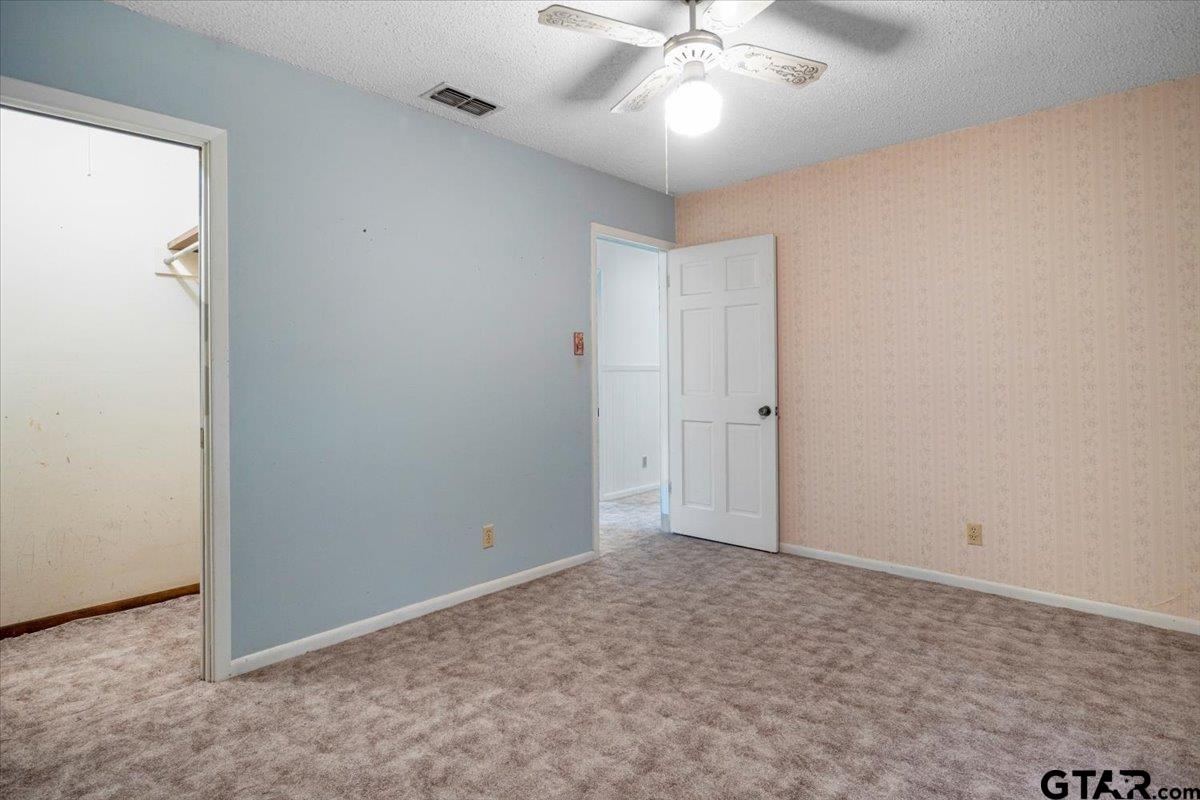 1302 Jeb Stuart Drive Tyler, TX 75703 - Photo 30 of 47 an empty room with a ceiling fan and a window