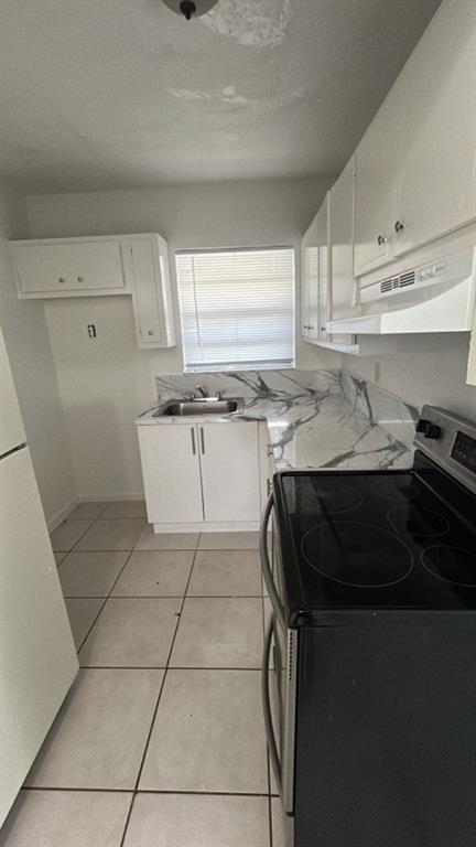 2245 Madison Street Hollywood, FL 33020 - Photo 5 of 6 a kitchen with a sink a stove and cabinets