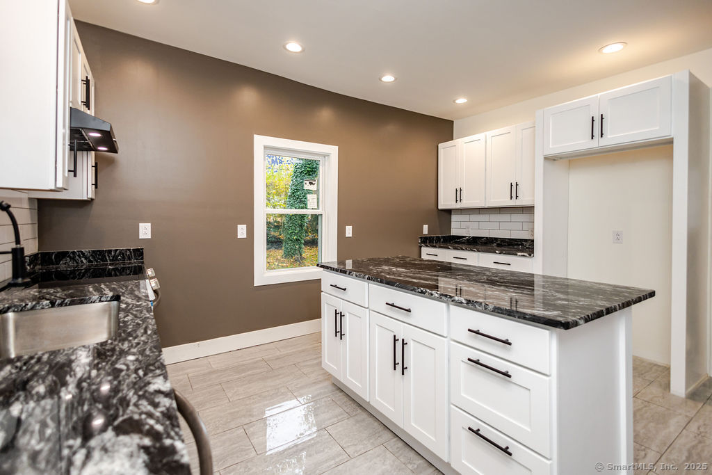 7 Florence Street Putnam, CT 06260 - Photo 13 of 38 a kitchen with stainless steel appliances granite countertop a stove and a sink
