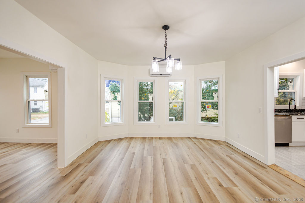 7 Florence Street Putnam, CT 06260 - Photo 14 of 38 a view of empty room with wooden floor and fan