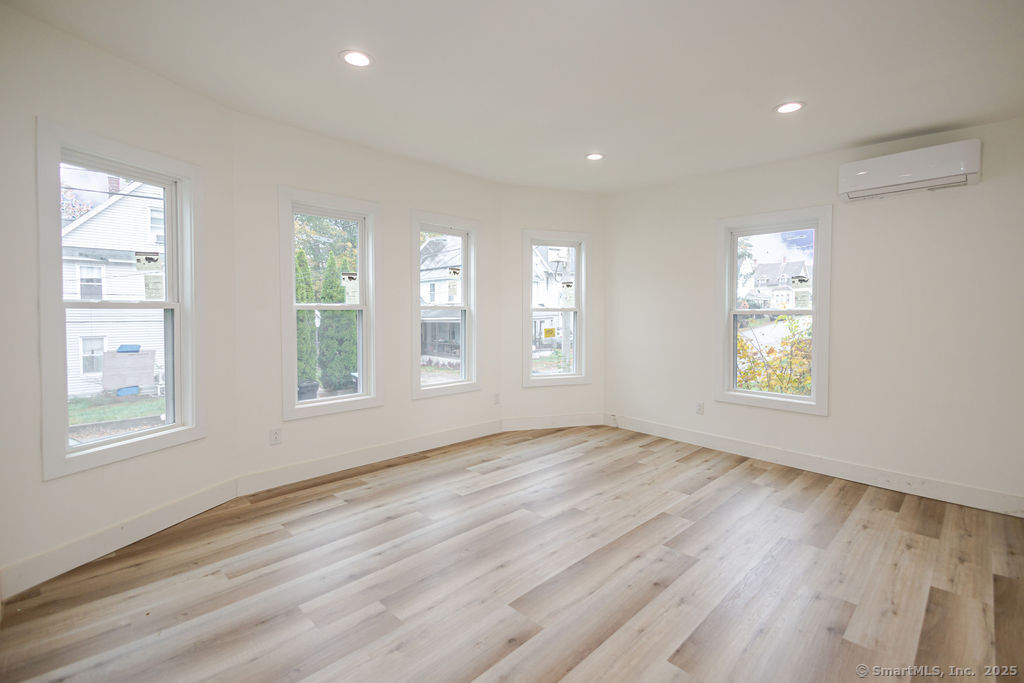7 Florence Street Putnam, CT 06260 - Photo 17 of 38 a view of an empty room with wooden floor and window