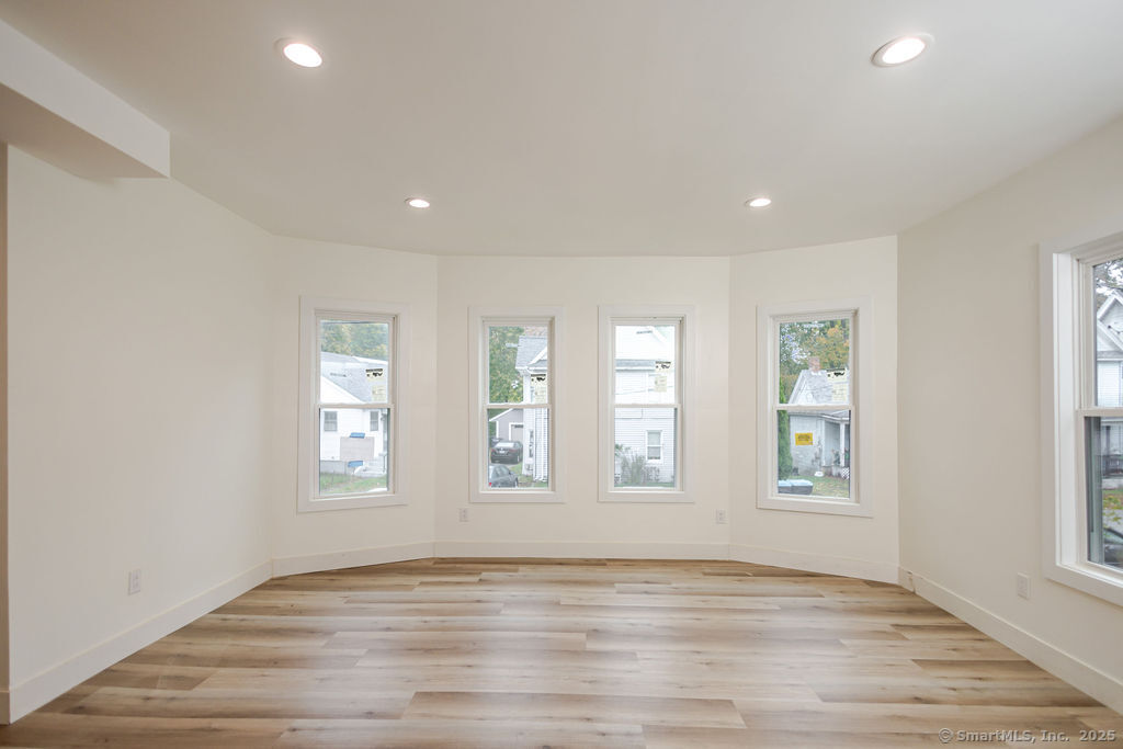 7 Florence Street Putnam, CT 06260 - Photo 18 of 38 an empty room with wooden floor and windows