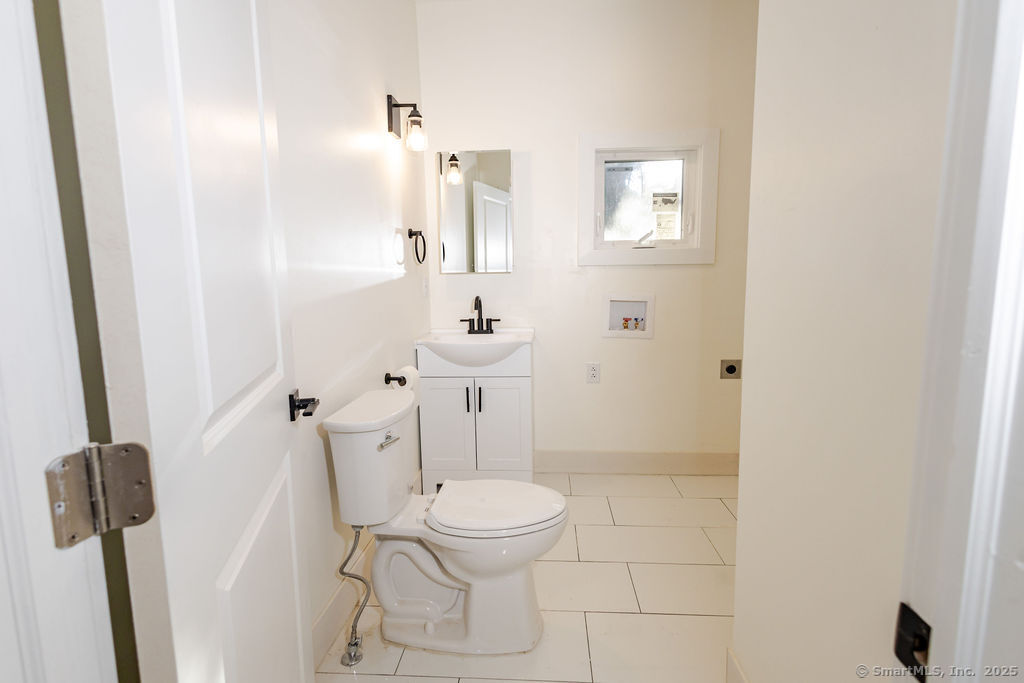 7 Florence Street Putnam, CT 06260 - Photo 26 of 38 a bathroom with a sink a toilet and shower