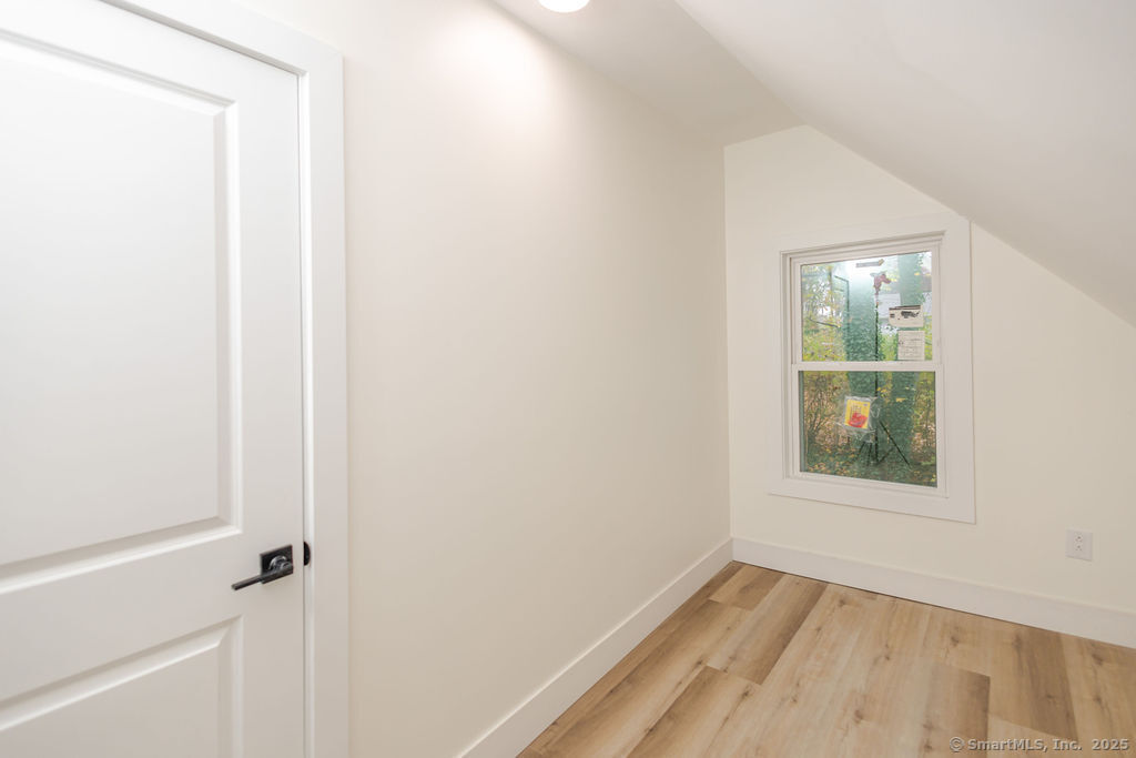 7 Florence Street Putnam, CT 06260 - Photo 33 of 38 a view of an empty room with wooden floor and a window