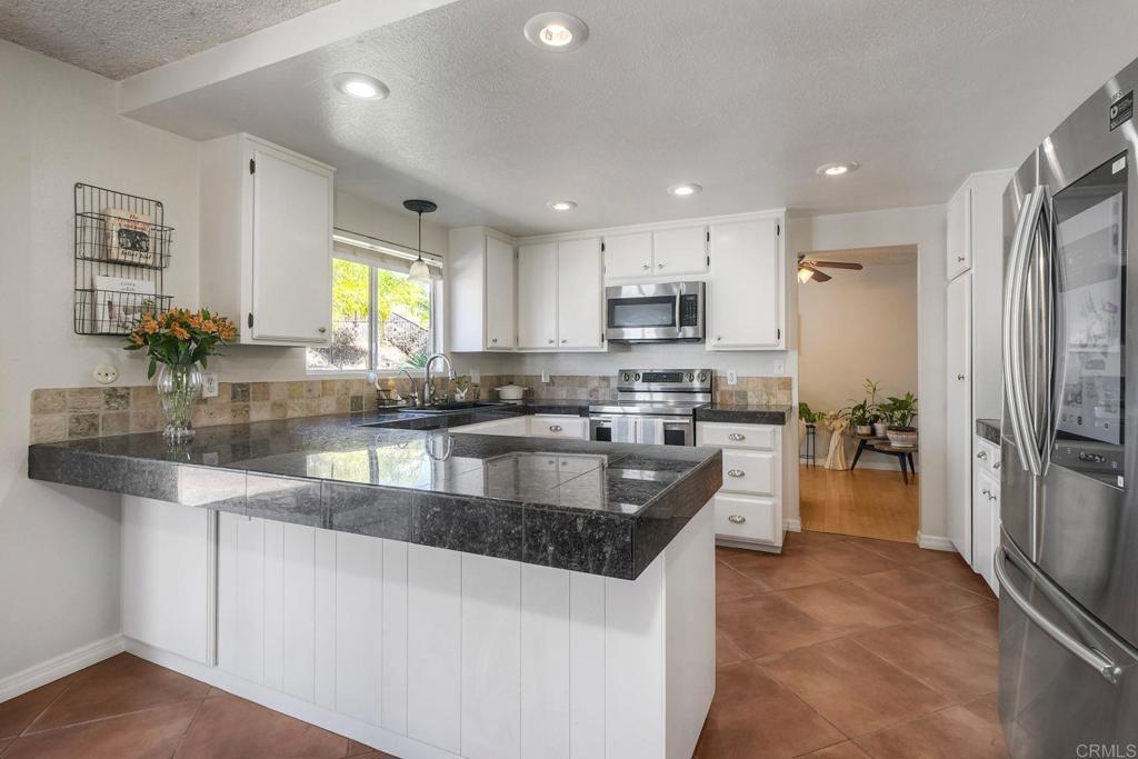 554 Taylor Street Vista, CA 92084 - Photo 17 of 51 a kitchen with stainless steel appliances granite countertop a refrigerator sink and stove