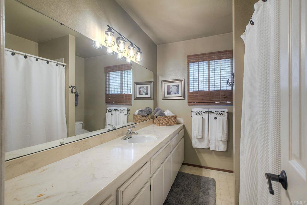 554 Taylor Street Vista, CA 92084 - Photo 23 of 51 a room with a sink and a large mirror