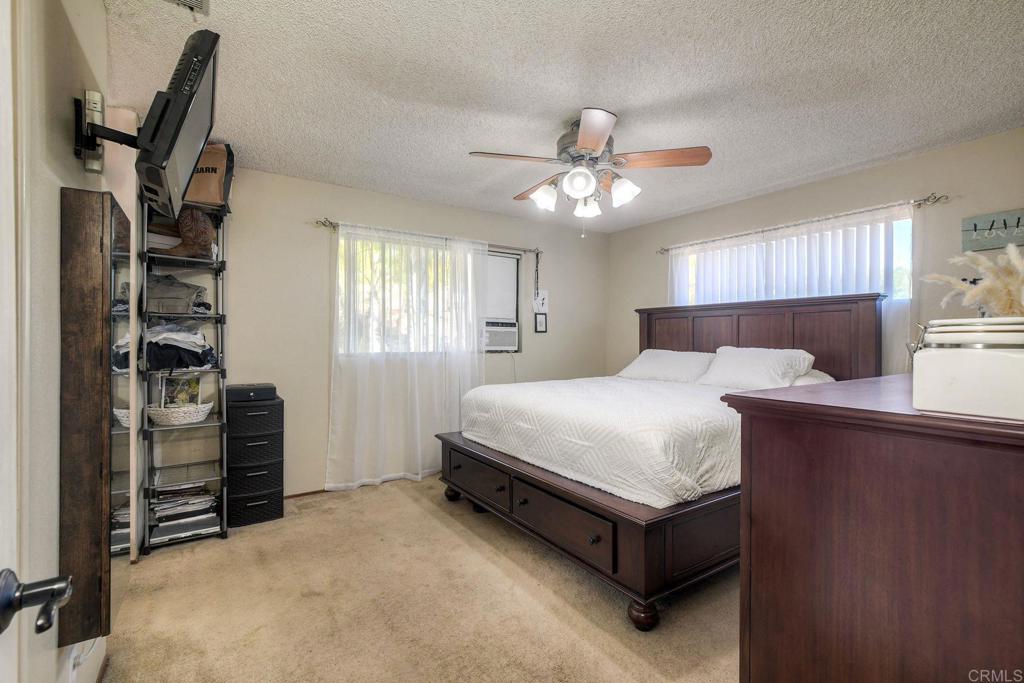 554 Taylor Street Vista, CA 92084 - Photo 24 of 51 a bedroom with a bed and dresser with wooden floor