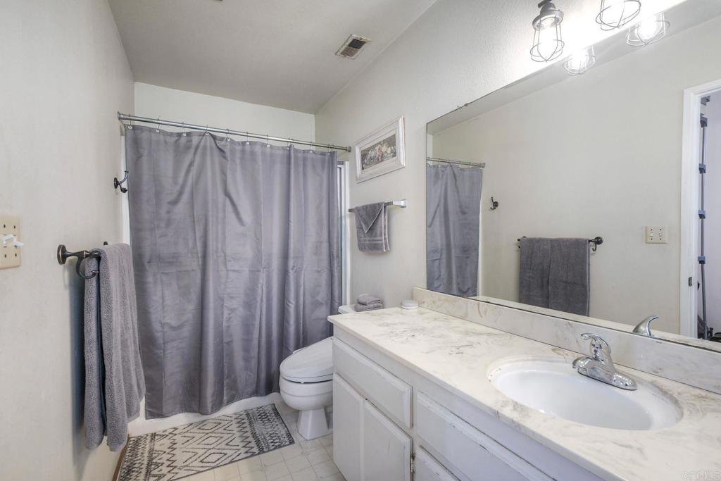 554 Taylor Street Vista, CA 92084 - Photo 29 of 51 a bathroom with a sink toilet and shower