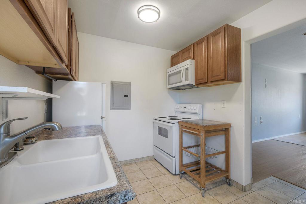 554 Taylor Street Vista, CA 92084 - Photo 41 of 51 a kitchen with a sink appliances and cabinets