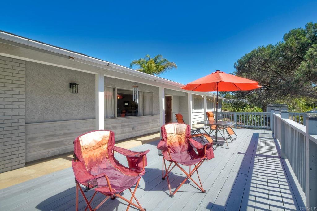 554 Taylor Street Vista, CA 92084 - Photo 50 of 51 a view of a patio with couches and table and chairs under an umbrella
