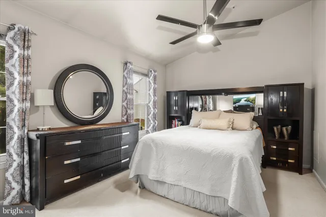 a bedroom with a bed and a mirror on dresser