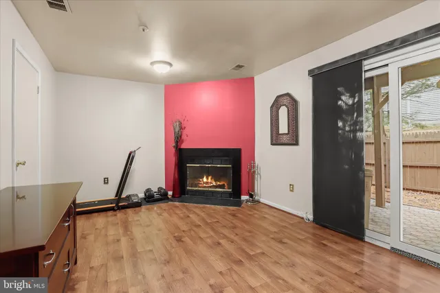 a view of a livingroom with a fireplace and window