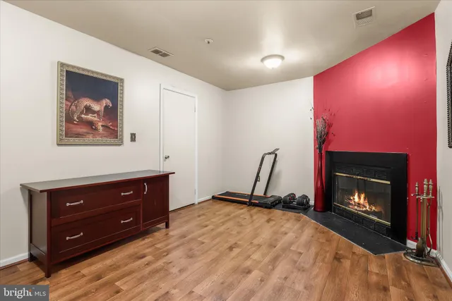 a room with a fireplace and a television