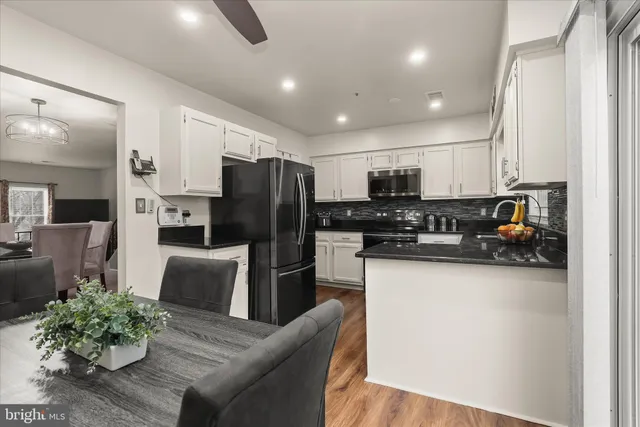 a kitchen with stainless steel appliances a refrigerator sink stove microwave and cabinets