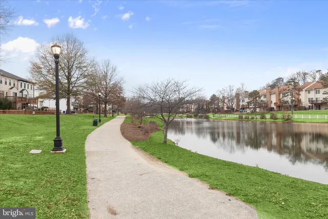 a view of a lake with a yard and a fountain