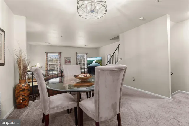 a dining room with furniture a rug and wooden floor