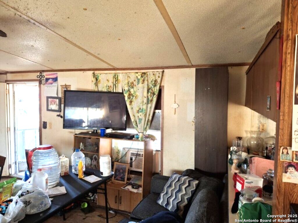 615 Viewpoint Drive Poteet, TX 78065 - Photo 2 of 9 a living room with furniture and a flat screen tv