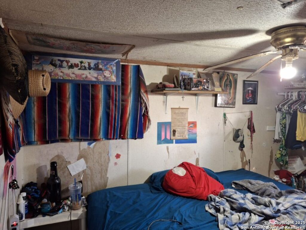 615 Viewpoint Drive Poteet, TX 78065 - Photo 4 of 9 a living room with lots of furniture and clothes