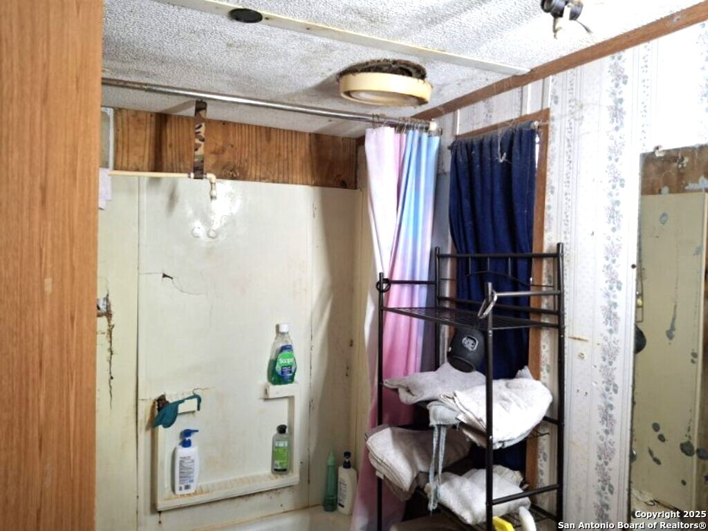 615 Viewpoint Drive Poteet, TX 78065 - Photo 5 of 9 a view of walk in closet with clothes and shoes