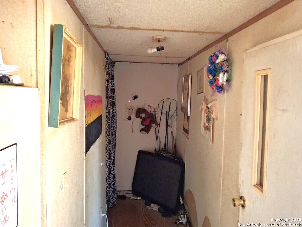 615 Viewpoint Drive Poteet, TX 78065 - Photo 6 of 9 a view of a hallway with furniture and a window