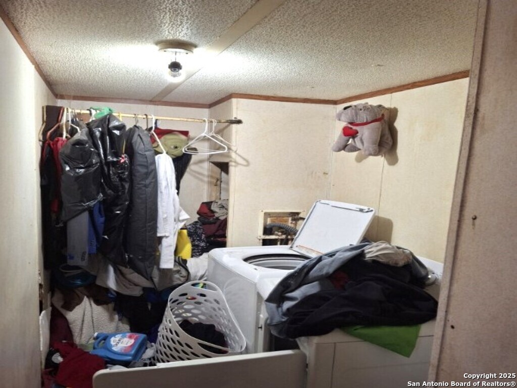 615 Viewpoint Drive Poteet, TX 78065 - Photo 7 of 9 a bed room with a bed and a walk in closet