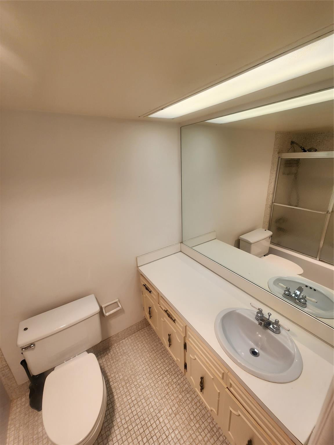 3051 North Course Drive Pompano Beach, FL 33069 - Photo 5 of 13 a bathroom with a sink a toilet and vanity