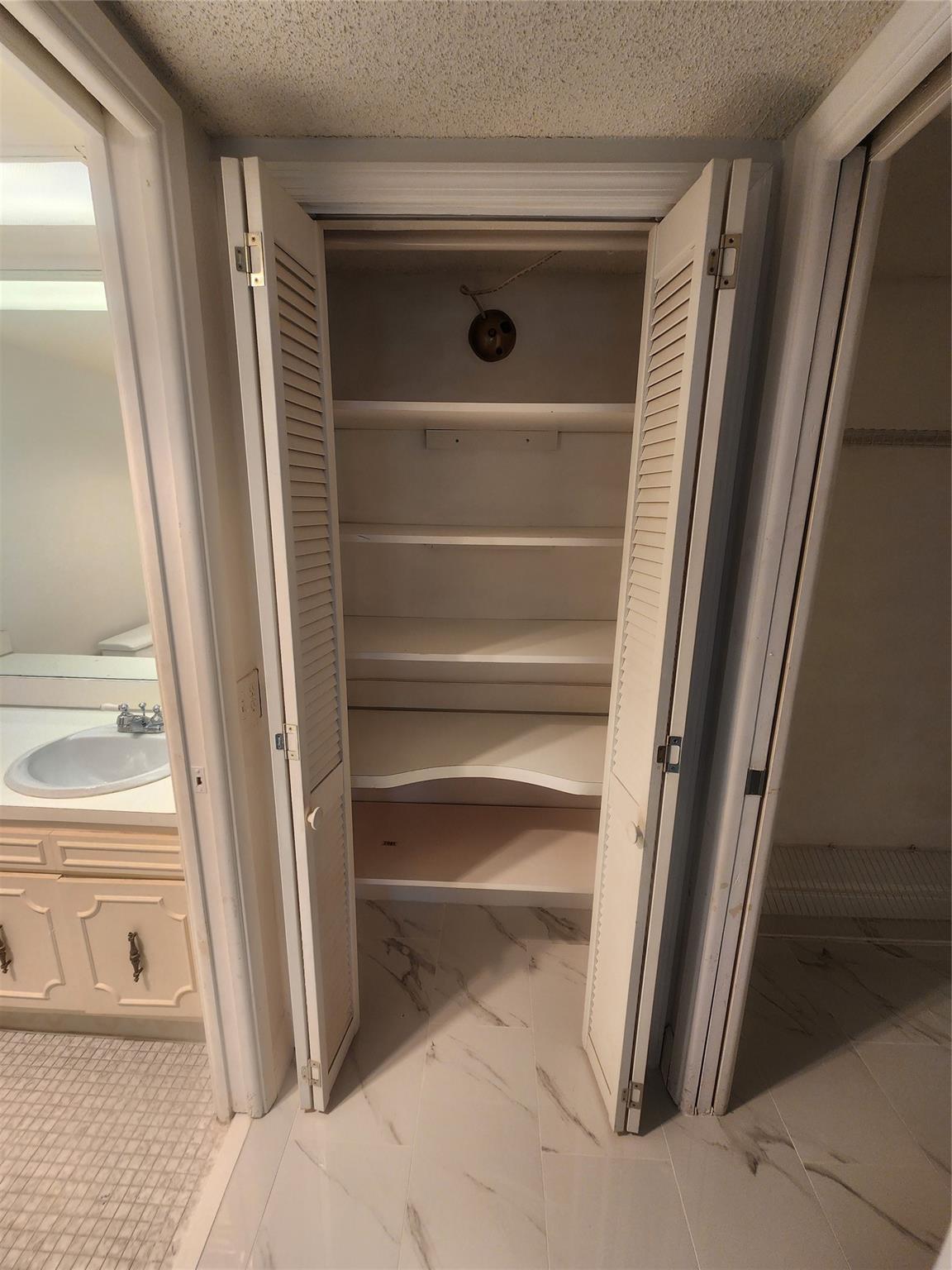 3051 North Course Drive Pompano Beach, FL 33069 - Photo 7 of 13 a view of walk in closet with wooden floor