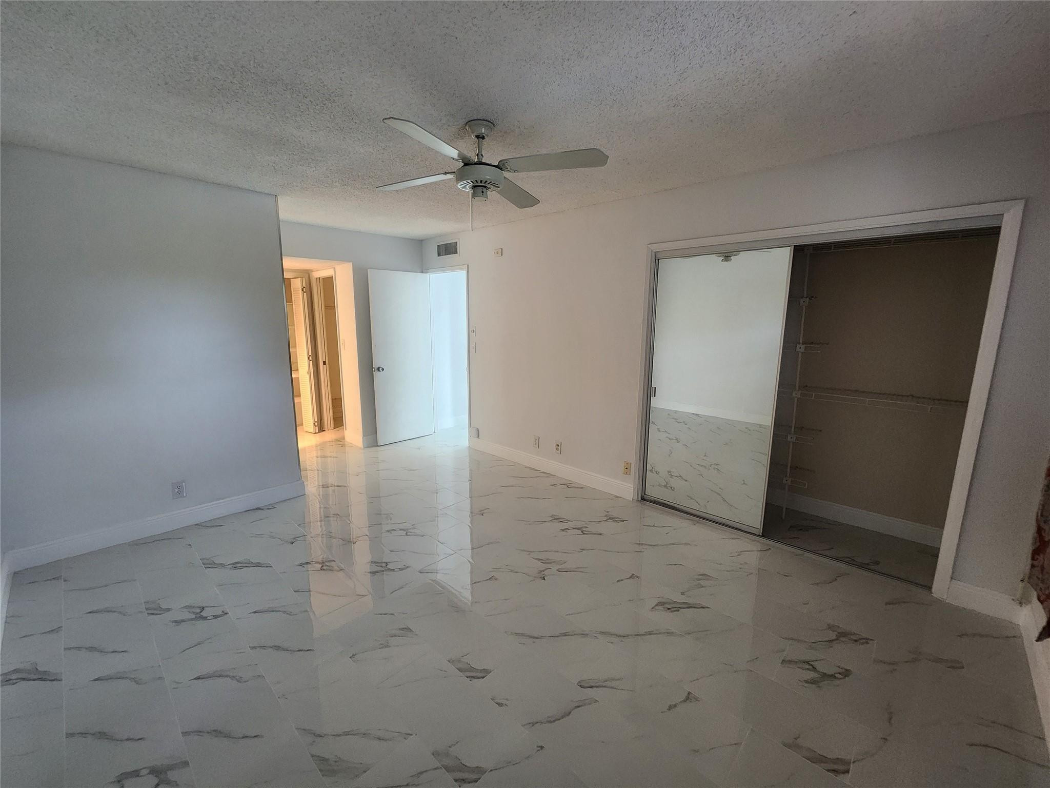 3051 North Course Drive Pompano Beach, FL 33069 - Photo 8 of 13 wooden floor in an empty room