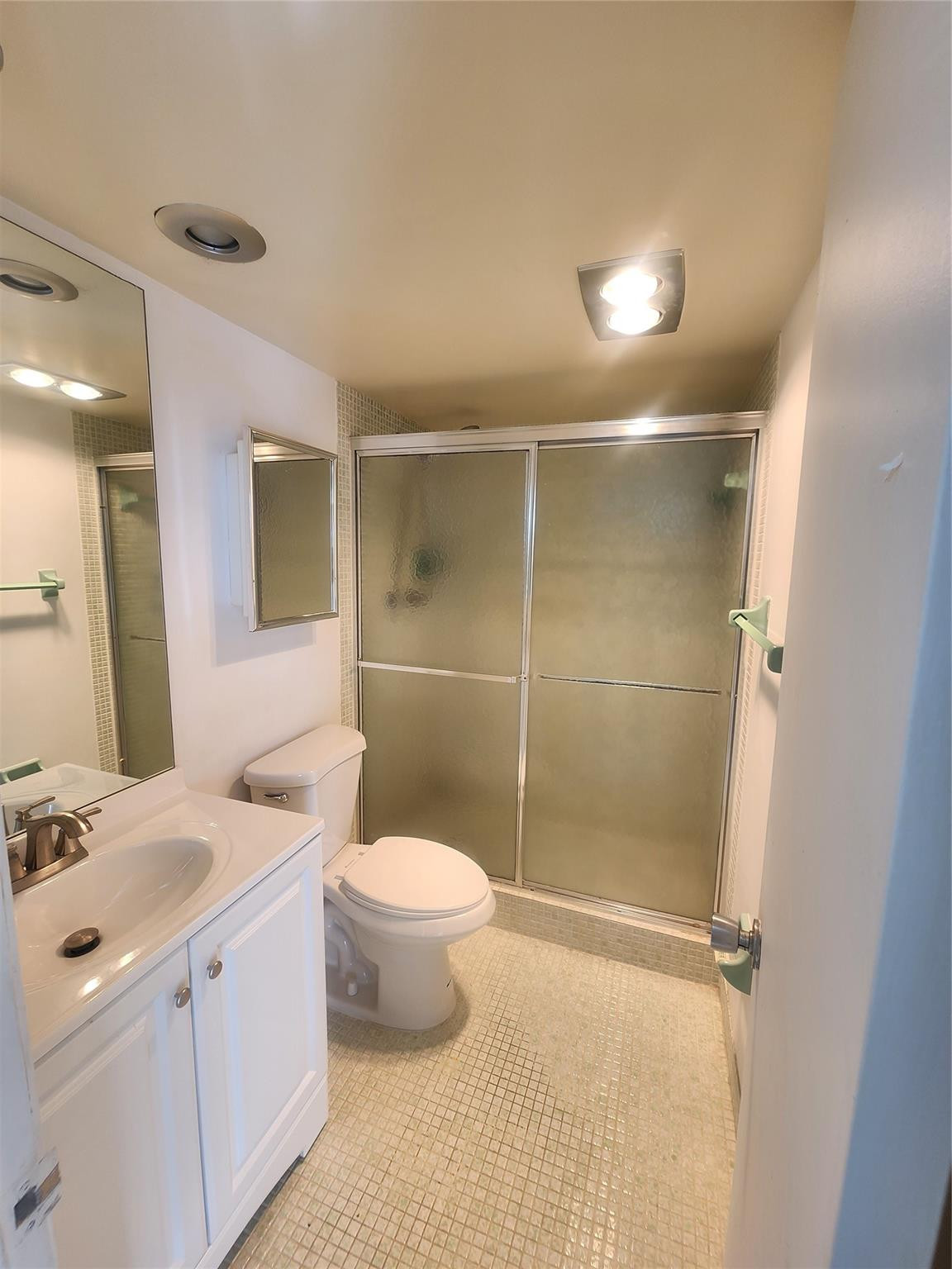 3051 North Course Drive Pompano Beach, FL 33069 - Photo 9 of 13 a bathroom with a granite countertop sink toilet and shower