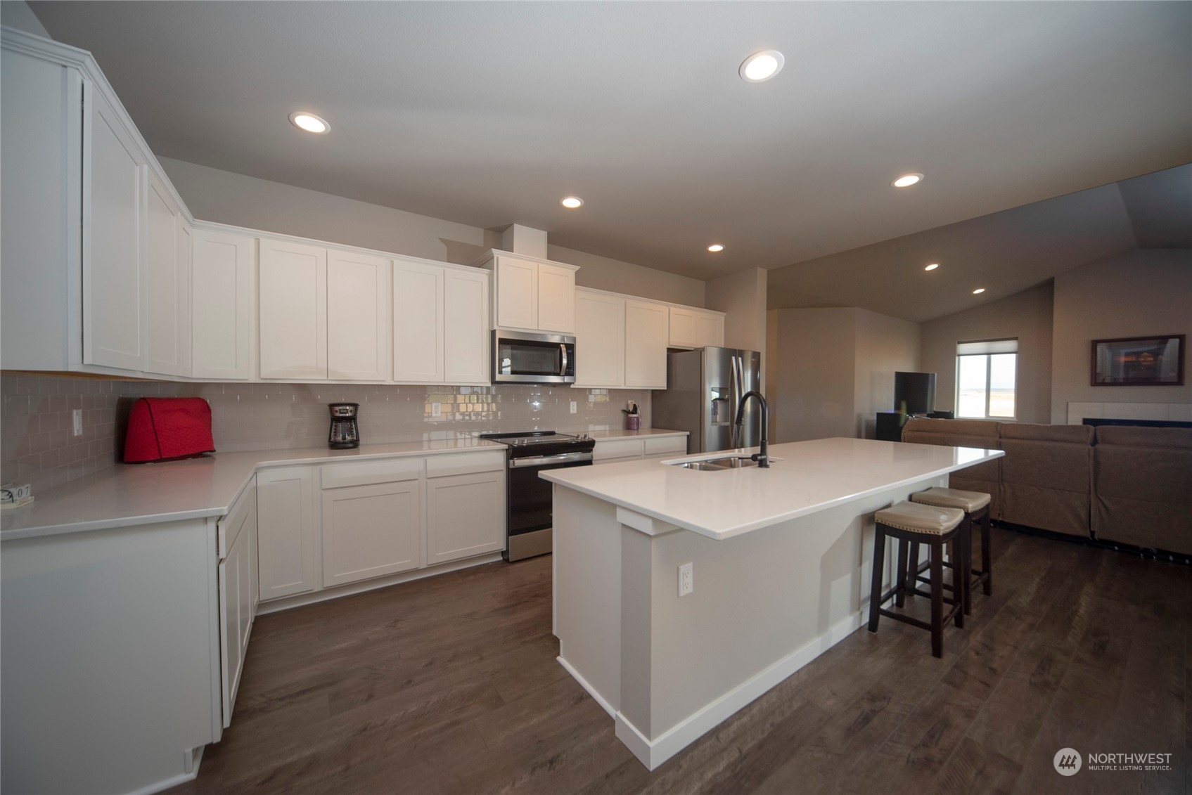 570 Green Canyon Road Ellensburg, WA 98926 - Photo 12 of 34 a kitchen with a sink a stove a refrigerator and white cabinets