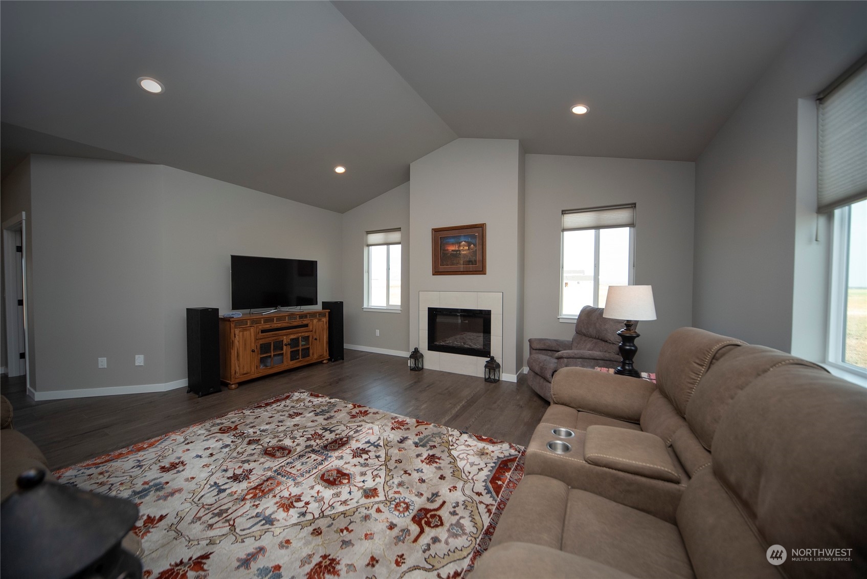 570 Green Canyon Road Ellensburg, WA 98926 - Photo 16 of 34 a living room with furniture a flat screen tv and a fireplace