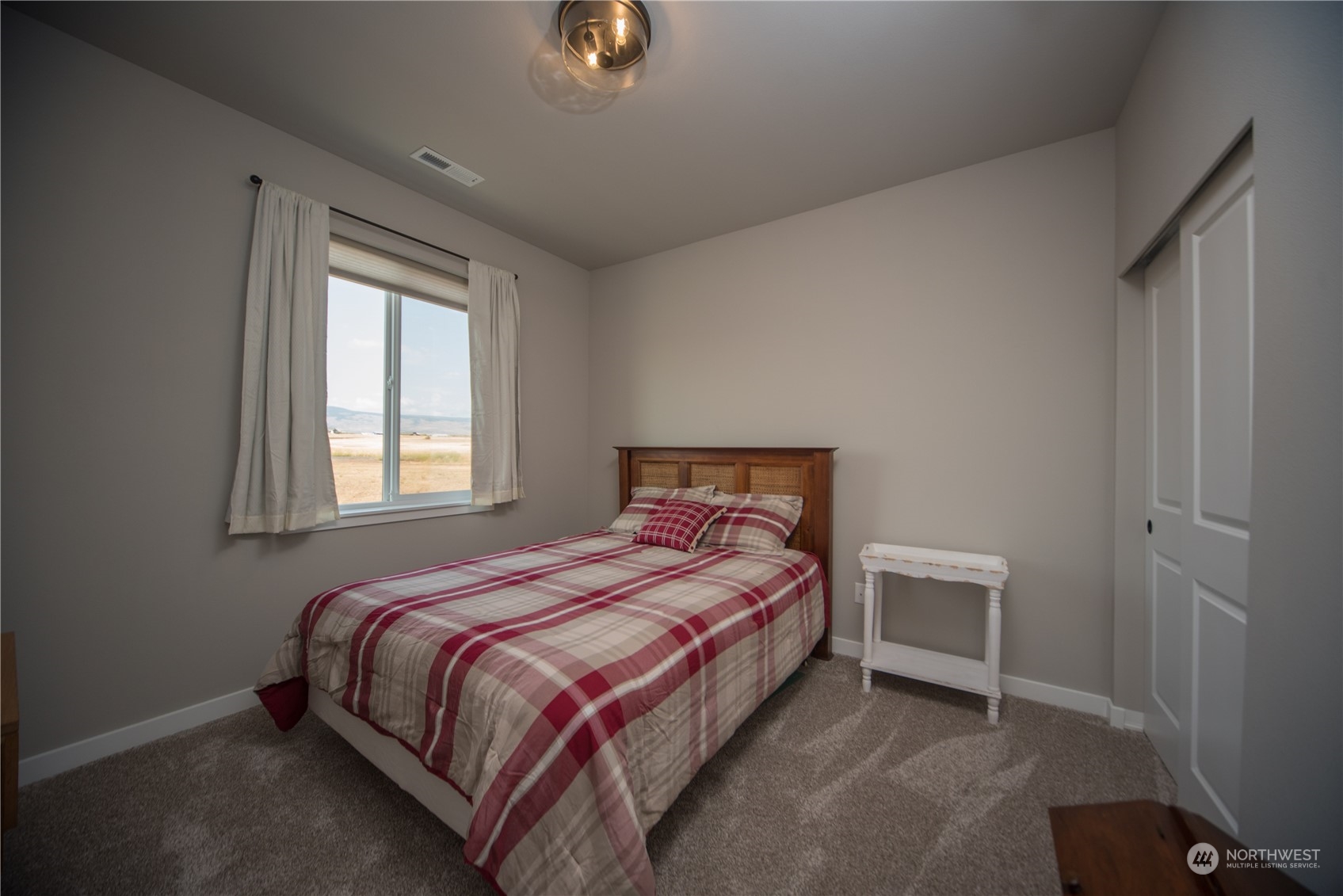 570 Green Canyon Road Ellensburg, WA 98926 - Photo 24 of 34 a bed sitting in a bedroom next to a window