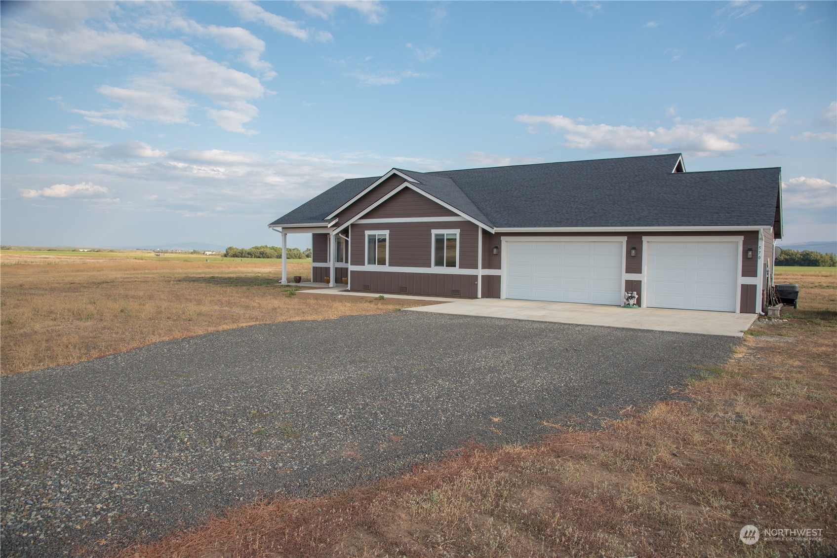 570 Green Canyon Road Ellensburg, WA 98926 - Photo 34 of 34 a front view of a house with a yard and garage