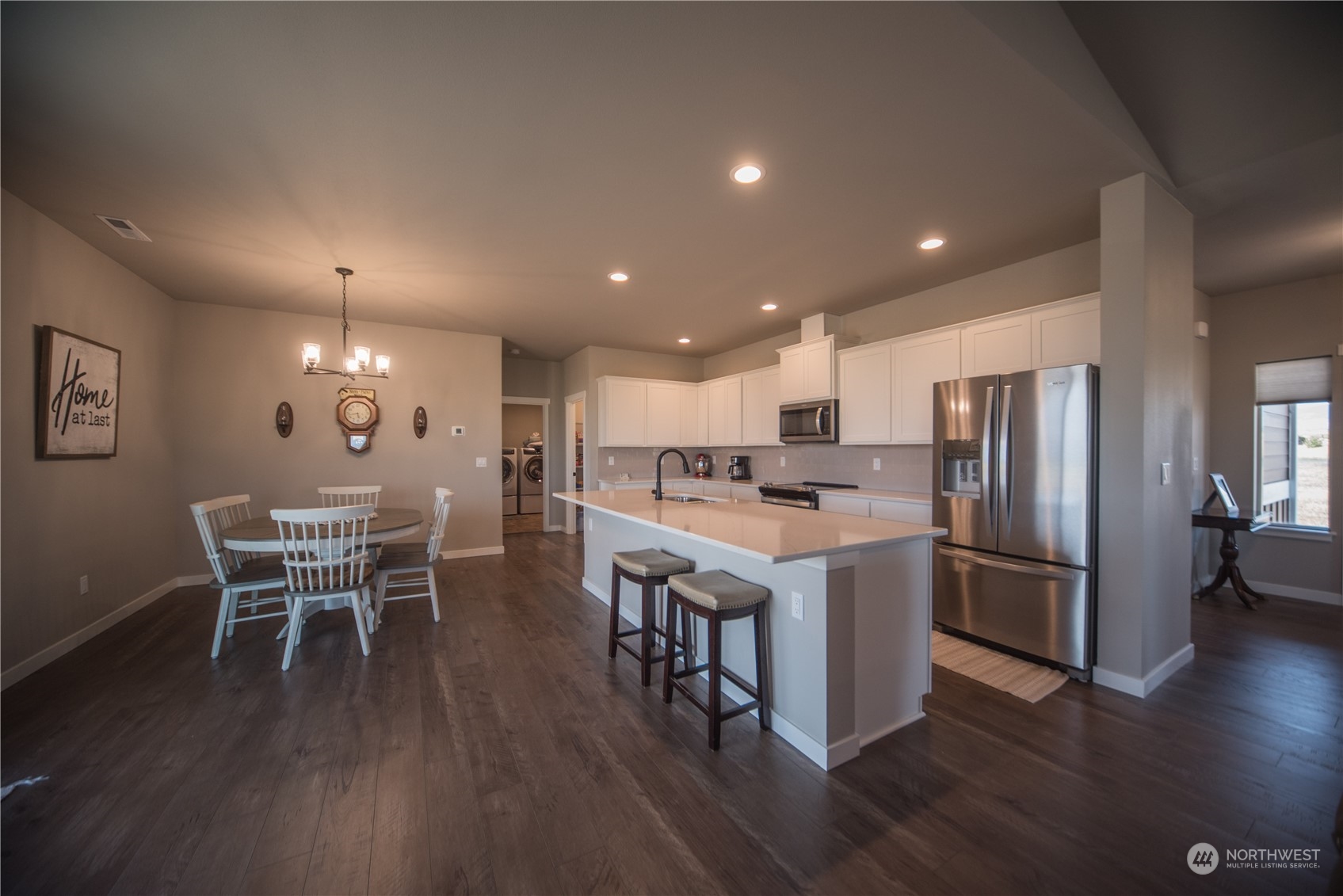 570 Green Canyon Road Ellensburg, WA 98926 - Photo 8 of 34 a kitchen with a dining table chairs wooden floor and stainless steel appliances