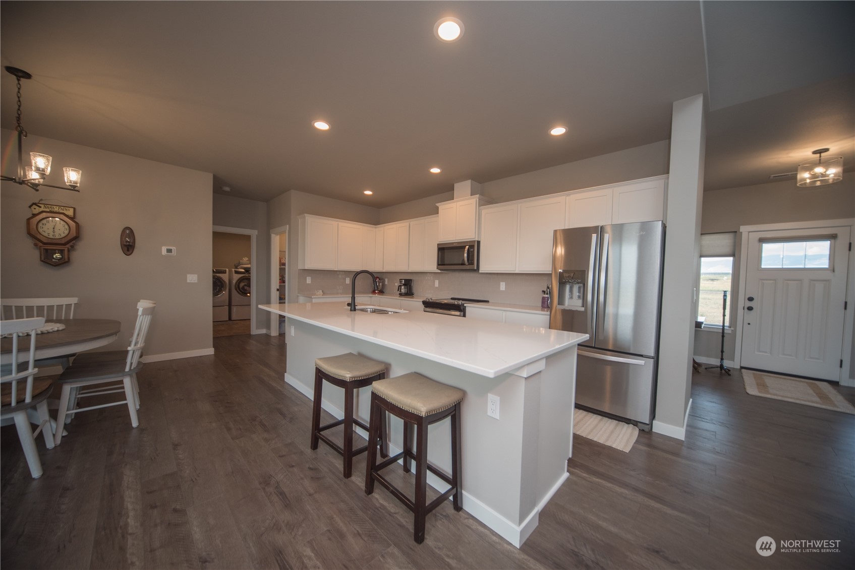 570 Green Canyon Road Ellensburg, WA 98926 - Photo 9 of 34 a kitchen with stainless steel appliances kitchen island granite countertop a table chairs refrigerator and microwave