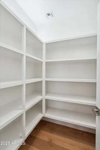 a view of walk in closet with empty racks