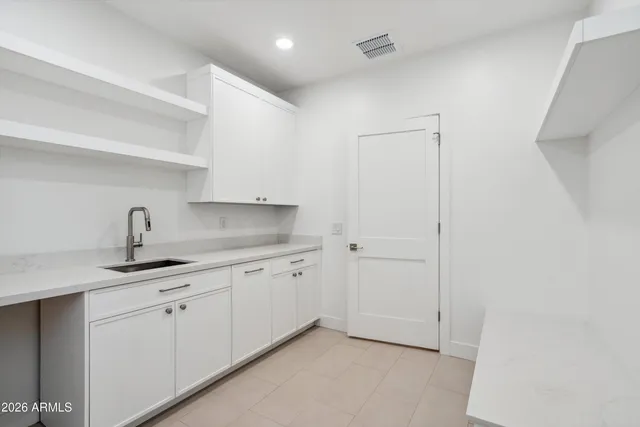 a kitchen with sink and cabinets