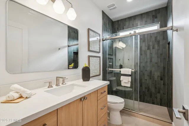 a bathroom with a sink toilet and shower