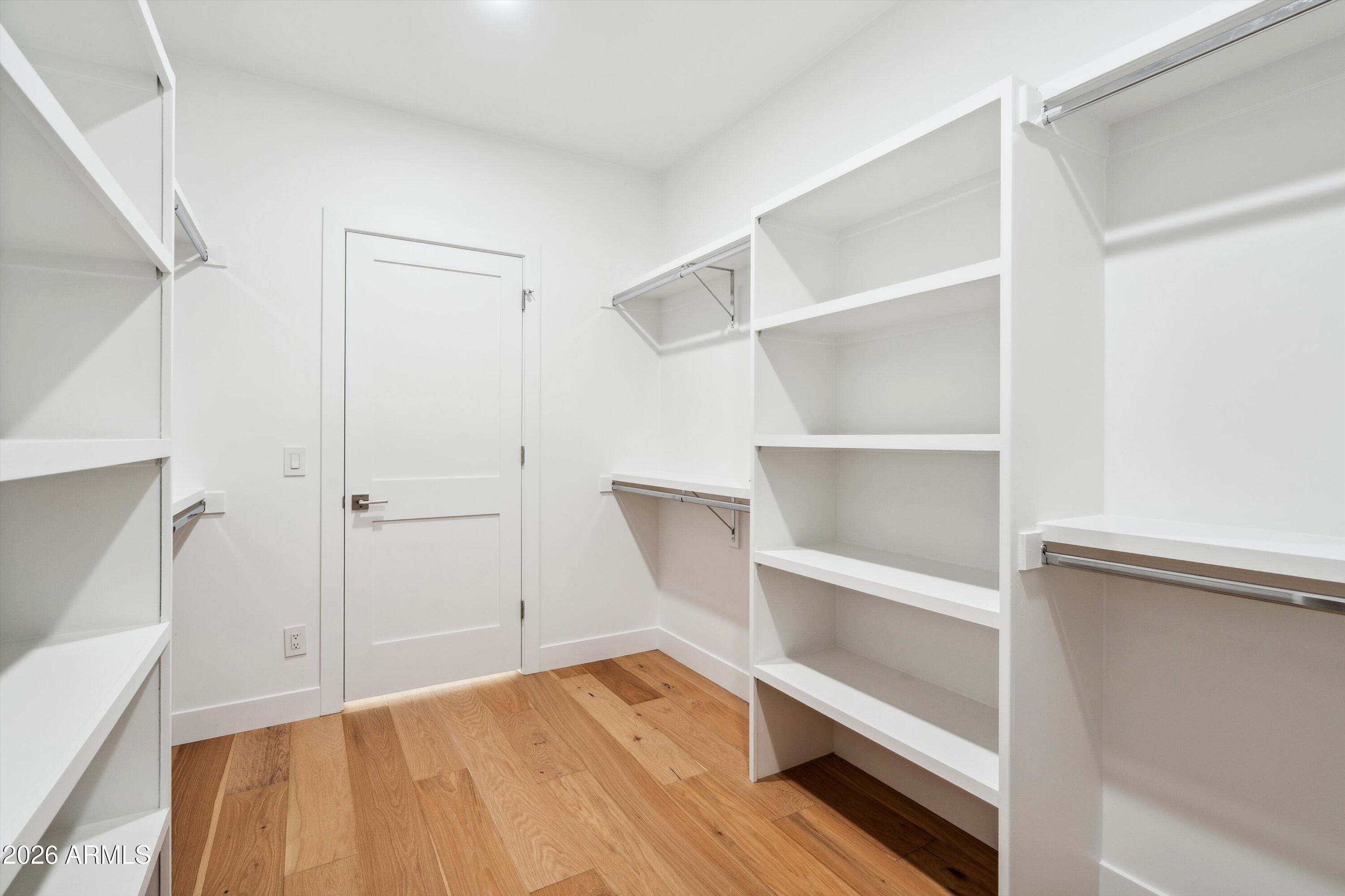 5533 East Earll Drive Phoenix, AZ 85018 - Photo 31 of 42 a view of an empty room with wooden floor and a window