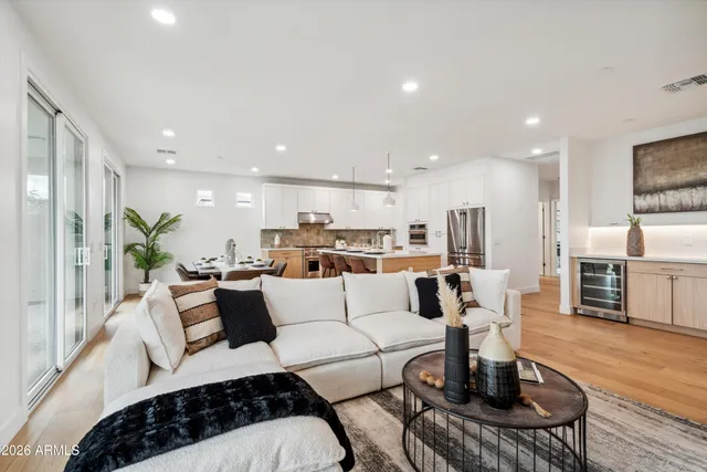 a living room with furniture a kitchen view and a kitchen view