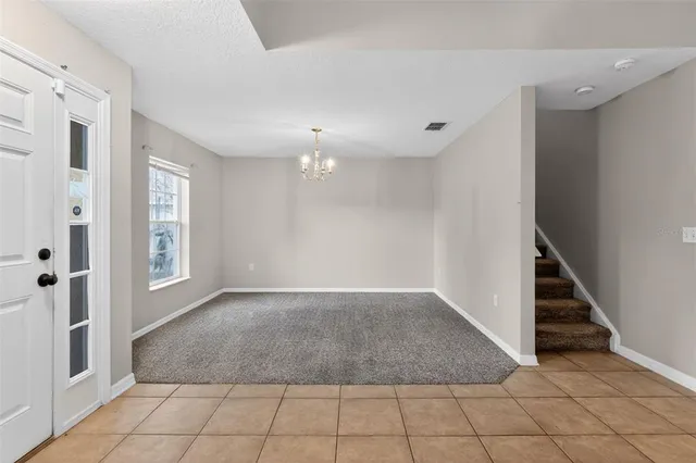 an empty room with windows and outdoor view