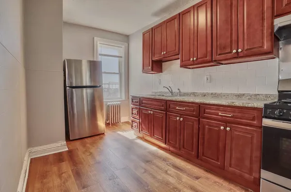 a kitchen with stainless steel appliances granite countertop a refrigerator sink and cabinets